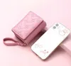 A pink wallet and a clear phone case with cartoon drawings are displayed on a pink background. Anteprima dell’immagine prodotto