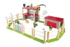 A toy dinosaur enclosure playset with wooden fences, a multi-level building, and several dinosaur figures. Produktbild-Vorschau