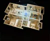 A 3D rendering of an apartment floor plan with an air purifier in the center and blue circles indicating its range. Produktbild-Vorschau