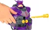 A child's hand is holding a toy gun accessory near a large purple robot toy. Anteprima dell’immagine prodotto