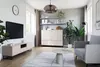 A modern living room with a beige RTV cabinet, a TV, a coffee table, and a sofa. Produktbild-Vorschau