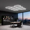 A modern office with a large window overlooking a city skyline at dusk, featuring a desk, chairs, and bookshelves. Voir les images du produit