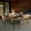 An outdoor dining set with a round table and six chairs on a patio. Produktbild-Vorschau