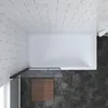 A top-down view of a modern bathroom with a bathtub and shower enclosure. Produktbild-Vorschau
