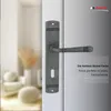 A close-up of a door handle on a door, with a blurred interior scene in the background. Produktbild-Vorschau