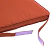 A close-up view of a terracotta-colored cushion with attached straps and velcro. Anteprima dell’immagine prodotto