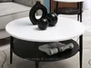 A round coffee table with decorative items and a magazine on it, placed in a living room setting. Náhľad obrázku produktu