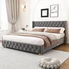 A bedroom scene featuring a gray upholstered bed with pillows and blankets. Voir les images du produit