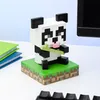 A Minecraft-themed panda desk lamp sits on a desk next to books and a keyboard. Náhled obrázku produktu