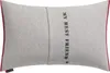 A rectangular pillow with a red border and text on it. Produktbild-Vorschau