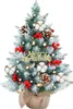 A small, decorated artificial Christmas tree on a white background. Produktbild-Vorschau