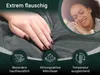 A hand resting on a soft, gray blanket, with a woman sleeping peacefully in the background. Produktbild-Vorschau