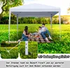 A family having a picnic under a white gazebo in a grassy park. Produktbild-Vorschau