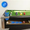 A cutaway view of a pool table showing the internal ball return system, with several pool balls on the table and one in the return system. Podgląd zdjęcia produktu