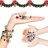 Hands holding Christmas-themed charms and bracelets against a white background with a Christmas garland at the top. Náhľad obrázku produktu