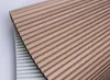 A close-up, angled view of two folded pleated blinds, one in a latte macchiato color and the other in a light gray color, against a white background. Produktbild-Vorschau