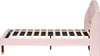 Side view of a pink upholstered bed frame with a wooden slatted base and dark wooden legs with gold accents. Náhľad obrázku produktu