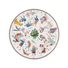 A round plate with a festive Christmas scene featuring children playing, a Christmas tree, and dogs. Produktbild-Vorschau