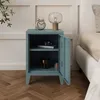 A blue metal nightstand with an open door, next to a bed. Anteprima dell’immagine prodotto