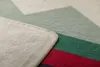 A close-up view of a folded blanket with a geometric pattern. Produktbild-Vorschau
