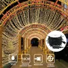 A decorative archway tunnel covered in warm white fairy lights, with a spool of lights in the foreground. Náhľad obrázku produktu