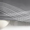 A close-up view of a gray fabric with a white water wave pattern, partially covering a book with text. Produktbild-Vorschau