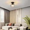 A modern living room with a sectional sofa, curtains, and a decorative ceiling light. Voir les images du produit