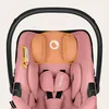 Close-up of a pink baby car seat with a black handle. Náhled obrázku produktu