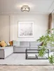 A modern living room with a sectional sofa, coffee table, and a large plant. Produktbild-Vorschau