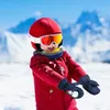 A child wearing ski gear in a snowy mountain environment. Náhled obrázku produktu