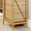 A close-up view of the lower portion of a bamboo laundry basket with a shelf. Podgląd zdjęcia produktu
