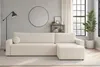 A modern living room with a cream-colored sectional sofa, a floor lamp, a round mirror, and a plant. Anteprima dell’immagine prodotto