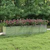 A raised garden bed filled with flowers in a garden setting. Náhľad obrázku produktu