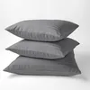 Three gray striped pillowcases stacked on top of each other against a white background. Anteprima dell’immagine prodotto