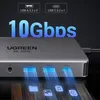 A close-up view of a UGREEN USB-C hub, highlighting its ports and speed capabilities with blue light effects. Produktbild-Vorschau