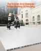 A person wearing roller skates stands on a white tiled floor in front of a building. Podgląd zdjęcia produktu