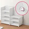 A white modular shelving unit with multiple shelves, shown against a white wall and on a wooden floor. Náhľad obrázku produktu