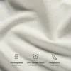 Close-up of a beige fabric with icons and text describing its features. Produktbild-Vorschau