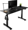 A black adjustable standing desk with a monitor, keyboard, mouse, lamp, headphones, and a potted plant. Náhľad obrázku produktu