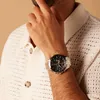 A man wearing a watch and a knitted shirt. Produktbild-Vorschau
