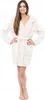 A woman wearing a white bathrobe stands against a white background. Náhľad obrázku produktu