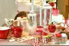 A collection of kitchenware and decorative items with a strawberry theme, displayed on a table. Produktbild-Vorschau