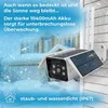 A security camera with solar panels mounted on a house exterior during a snowfall. Produktbild-Vorschau