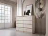 A modern bedroom or living room setting with a chest of drawers, artwork, and decorative elements. Náhled obrázku produktu