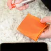 A person is cleaning a phone screen with a spray and cloth. Anteprima dell’immagine prodotto