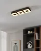 A modern living room with a ceiling light fixture and a bookshelf. Produktbild-Vorschau