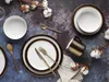 A flat lay of dinnerware and cutlery with cotton stems on a dark, textured surface. Náhľad obrázku produktu