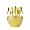 A set of golden cutlery in a golden holder. Produktbild-Vorschau