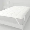 A white mattress topper on a bed. Produktbild-Vorschau