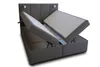 A gray upholstered bed frame with the mattress storage compartments open. Produktbild-Vorschau